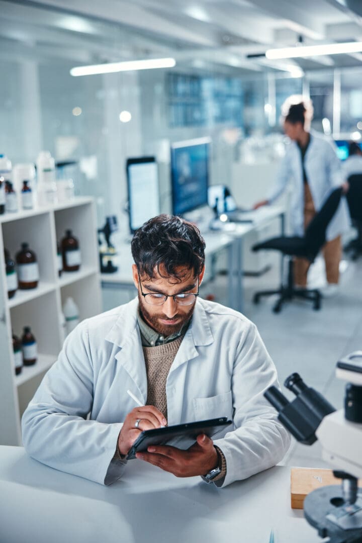 Scientist using tablet in modern laboratory.
